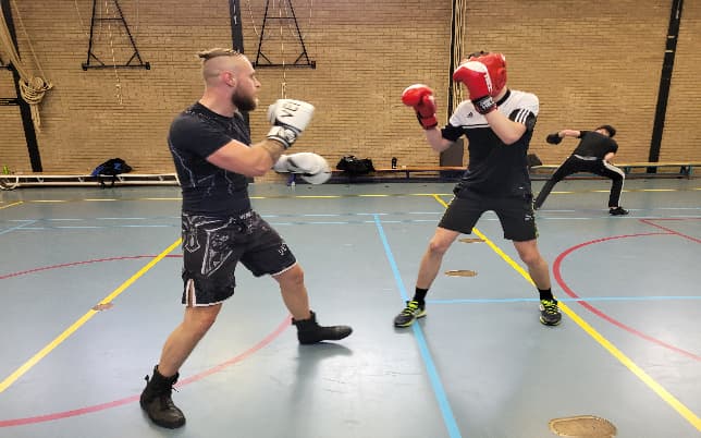 Twee leden sparren in de gymzaal
